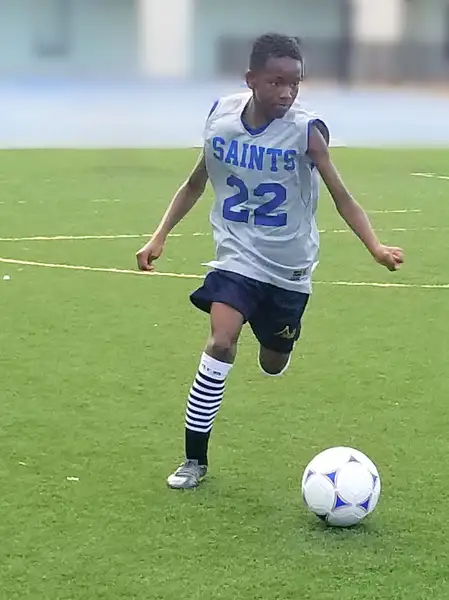 Saint boy playing soccer